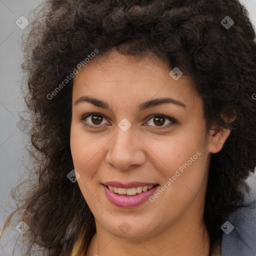 Joyful black young-adult female with long  brown hair and brown eyes