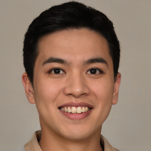 Joyful latino young-adult male with short  brown hair and brown eyes