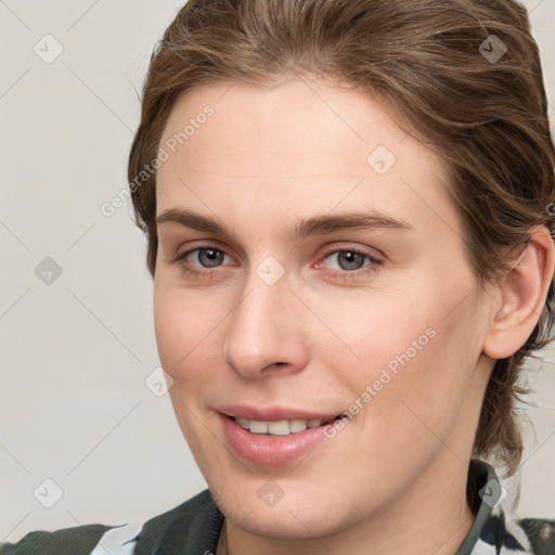 Joyful white young-adult female with medium  brown hair and blue eyes