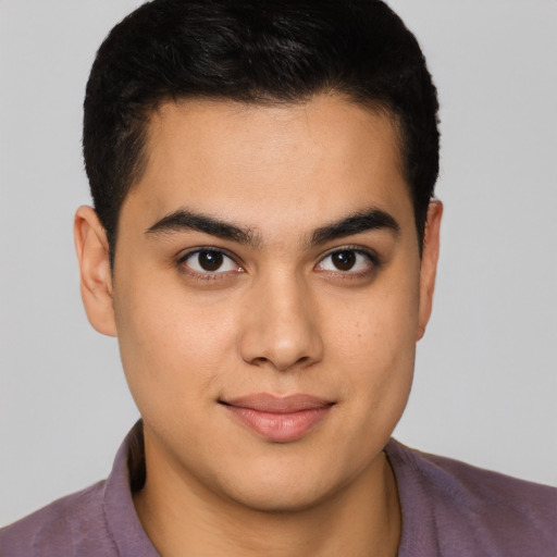 Joyful latino young-adult male with short  brown hair and brown eyes