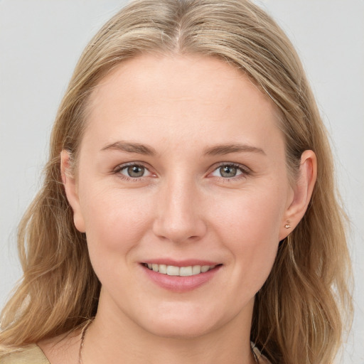 Joyful white young-adult female with long  brown hair and blue eyes