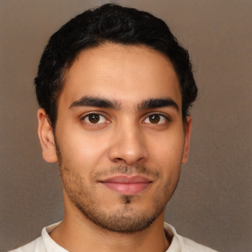 Joyful latino young-adult male with short  brown hair and brown eyes