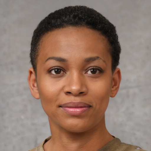 Joyful black young-adult female with short  black hair and brown eyes