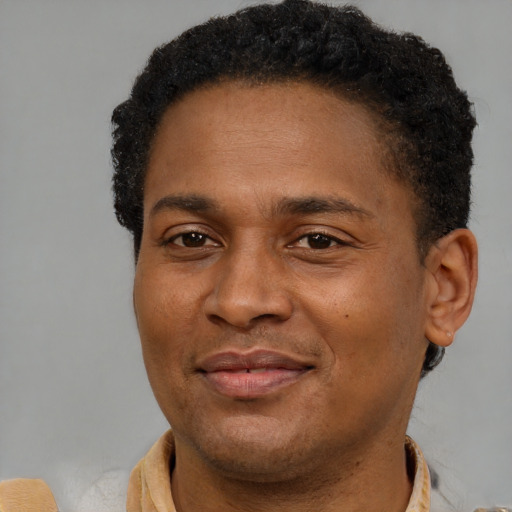 Joyful latino adult male with short  brown hair and brown eyes