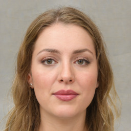 Joyful white young-adult female with long  brown hair and green eyes