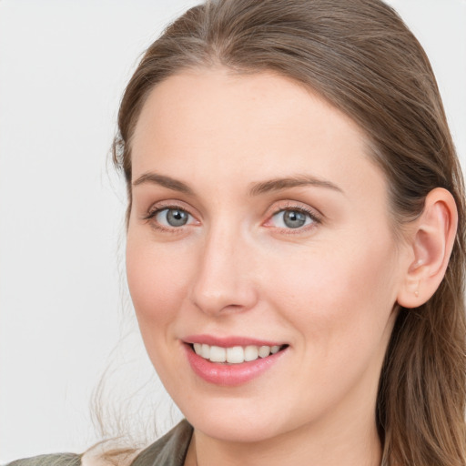 Joyful white young-adult female with long  brown hair and blue eyes