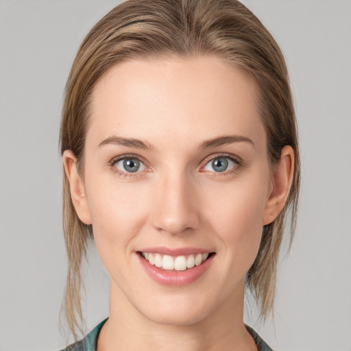 Joyful white young-adult female with medium  brown hair and blue eyes