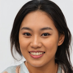 Joyful asian young-adult female with long  brown hair and brown eyes