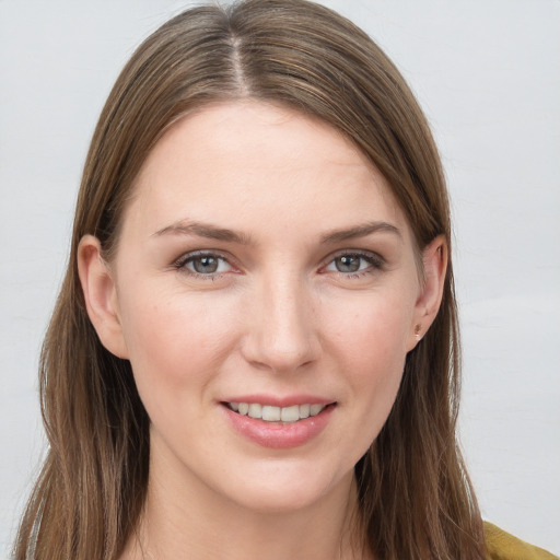 Joyful white young-adult female with long  brown hair and grey eyes