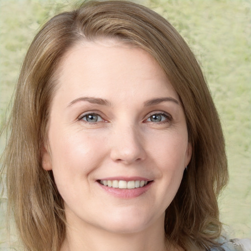 Joyful white young-adult female with medium  brown hair and green eyes