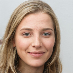 Joyful white young-adult female with long  brown hair and blue eyes