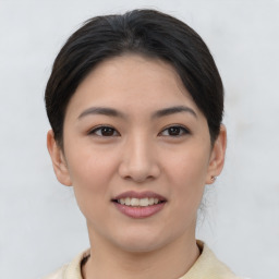 Joyful asian young-adult female with short  brown hair and brown eyes