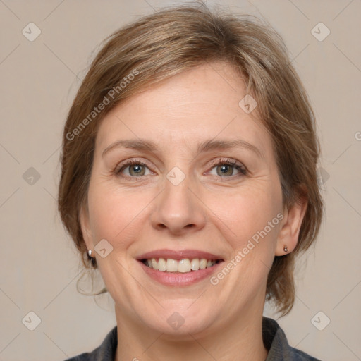 Joyful white adult female with medium  brown hair and grey eyes