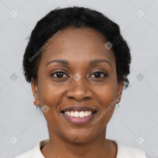 Joyful black young-adult female with short  black hair and brown eyes