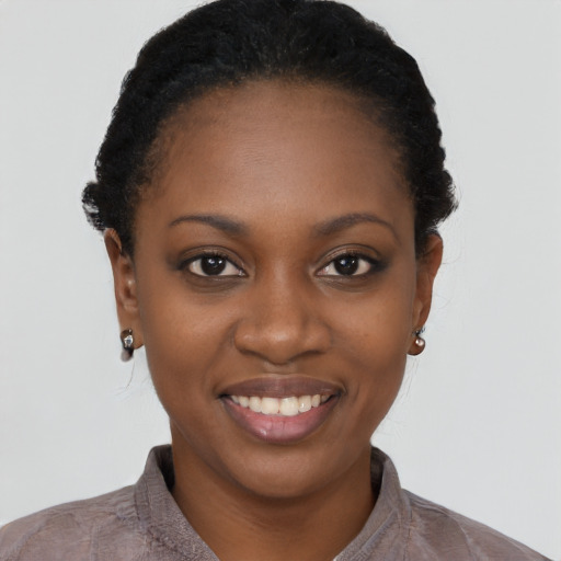 Joyful black young-adult female with short  black hair and brown eyes