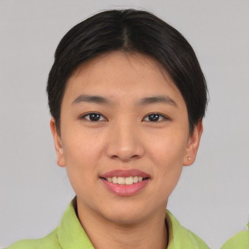 Joyful asian young-adult female with short  black hair and brown eyes