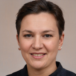 Joyful white adult female with short  brown hair and grey eyes