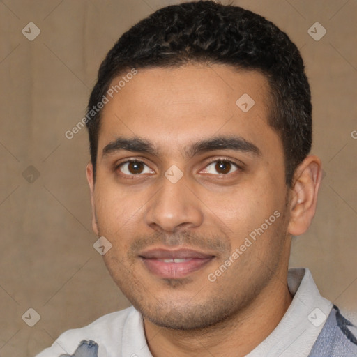 Joyful latino young-adult male with short  black hair and brown eyes