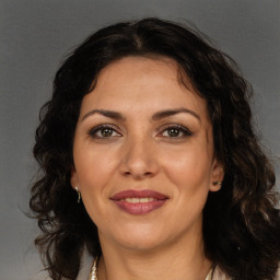 Joyful white adult female with long  brown hair and brown eyes