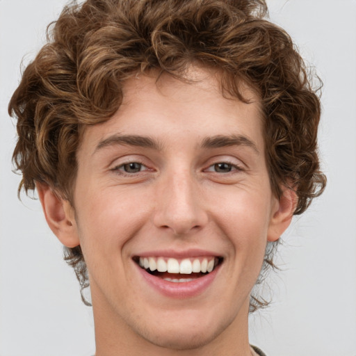 Joyful white young-adult male with short  brown hair and green eyes