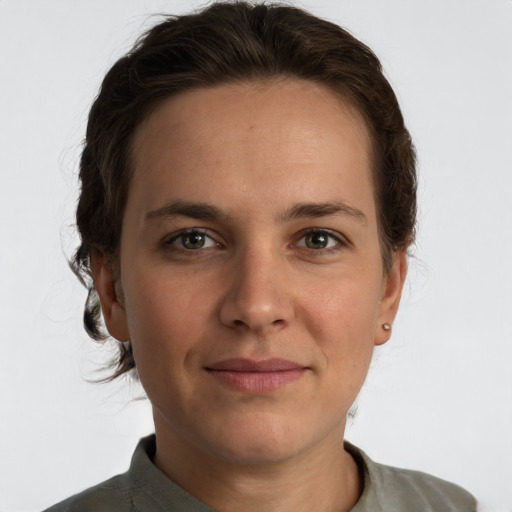 Joyful white adult female with short  brown hair and brown eyes