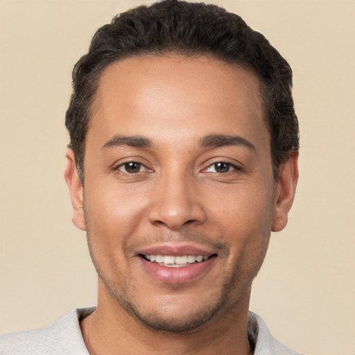 Joyful white young-adult male with short  black hair and brown eyes