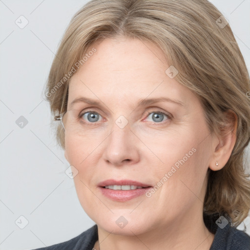 Joyful white adult female with medium  brown hair and blue eyes