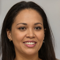 Joyful latino young-adult female with long  brown hair and brown eyes