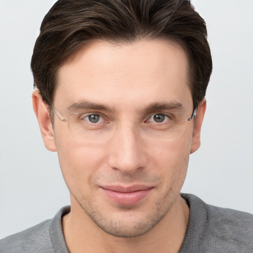 Joyful white young-adult male with short  brown hair and grey eyes