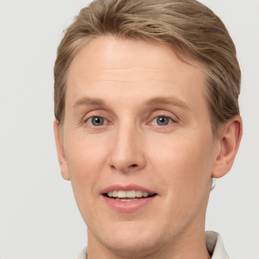 Joyful white adult male with short  brown hair and grey eyes