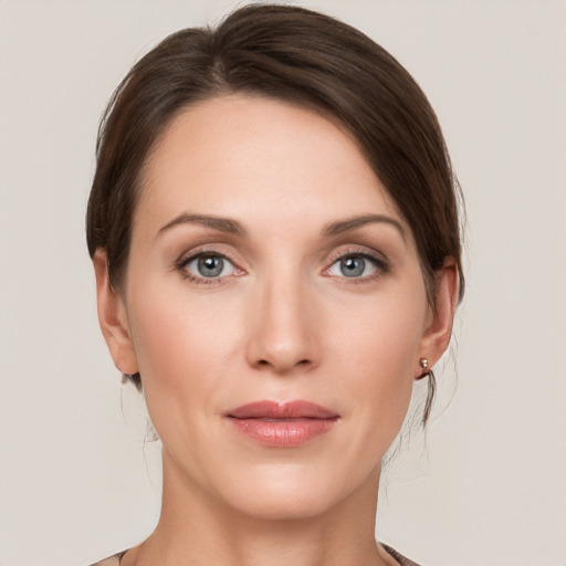 Joyful white young-adult female with medium  brown hair and grey eyes