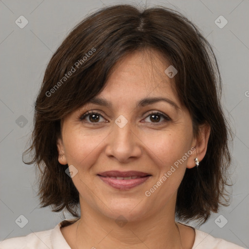 Joyful white adult female with medium  brown hair and brown eyes