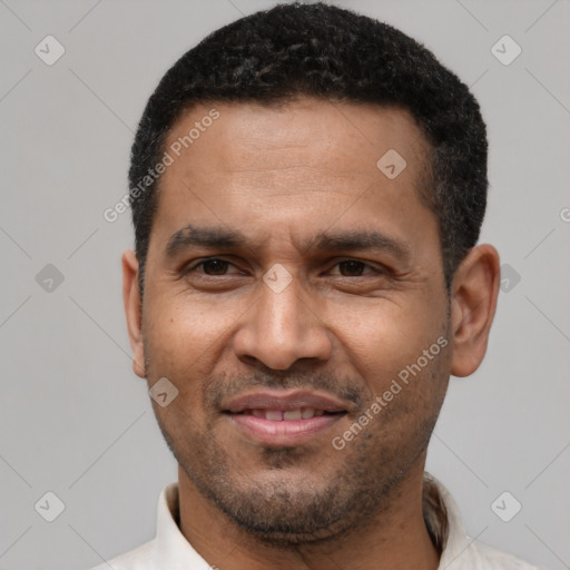 Joyful latino adult male with short  black hair and brown eyes