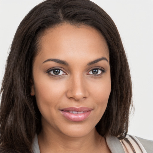 Joyful white young-adult female with long  brown hair and brown eyes