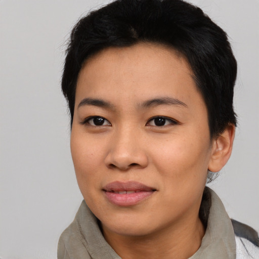 Joyful asian young-adult female with short  black hair and brown eyes