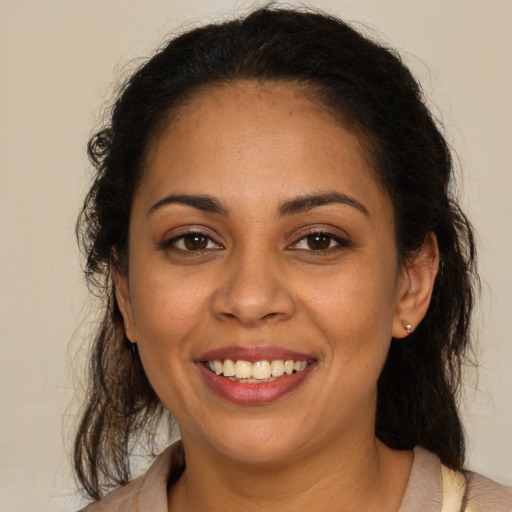 Joyful latino young-adult female with medium  brown hair and brown eyes