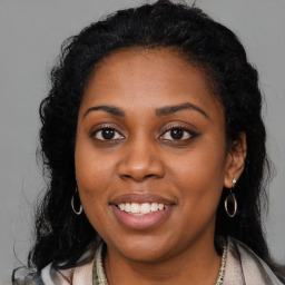 Joyful latino young-adult female with long  brown hair and brown eyes