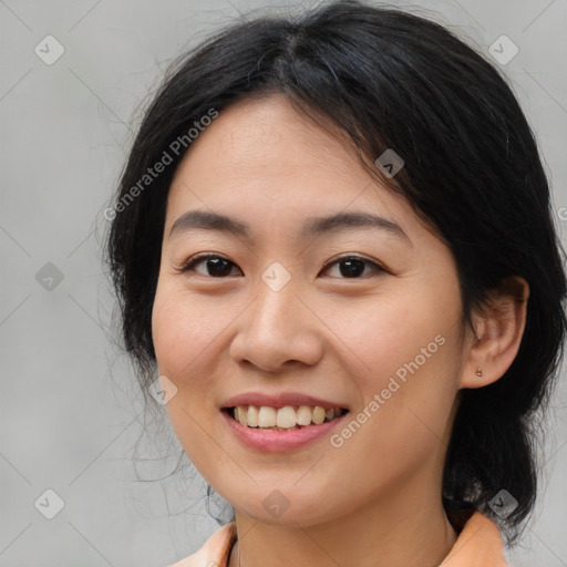 Joyful asian young-adult female with medium  black hair and brown eyes