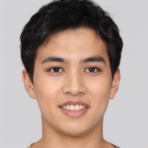 Joyful asian young-adult male with short  brown hair and brown eyes