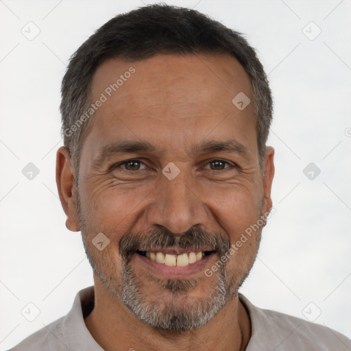 Joyful white adult male with short  black hair and brown eyes