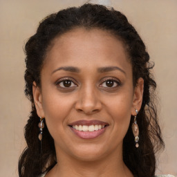 Joyful black young-adult female with long  brown hair and brown eyes