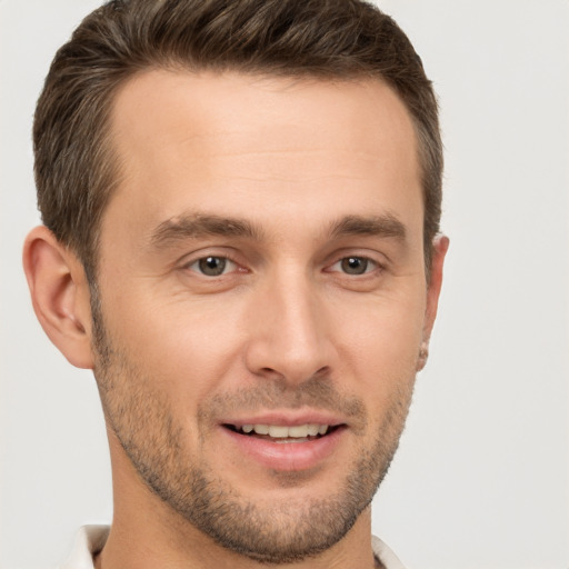 Joyful white young-adult male with short  brown hair and brown eyes