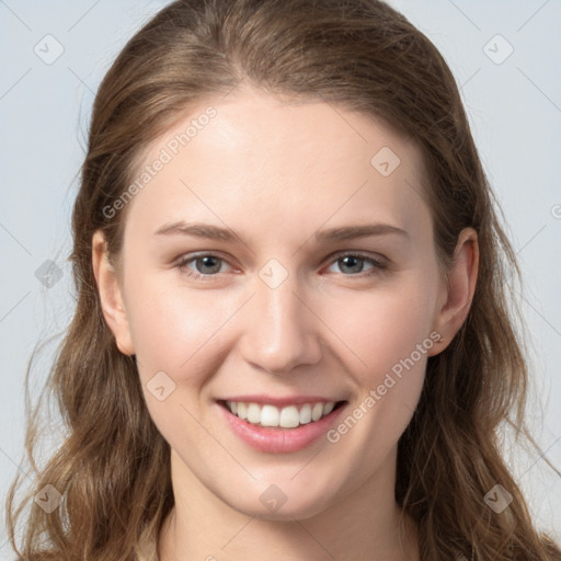 Joyful white young-adult female with long  brown hair and grey eyes