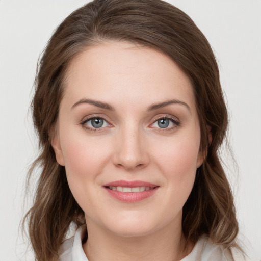 Joyful white young-adult female with medium  brown hair and green eyes