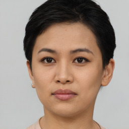 Joyful asian young-adult female with short  brown hair and brown eyes