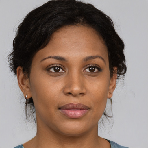 Joyful black young-adult female with medium  brown hair and brown eyes