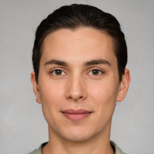 Joyful white young-adult male with short  brown hair and brown eyes