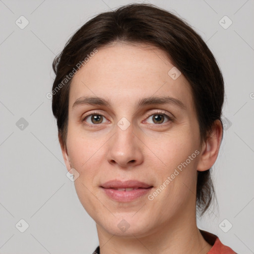 Joyful white young-adult female with medium  brown hair and grey eyes