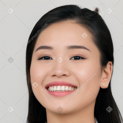 Joyful white young-adult female with long  black hair and brown eyes