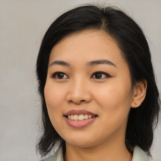 Joyful asian young-adult female with medium  black hair and brown eyes